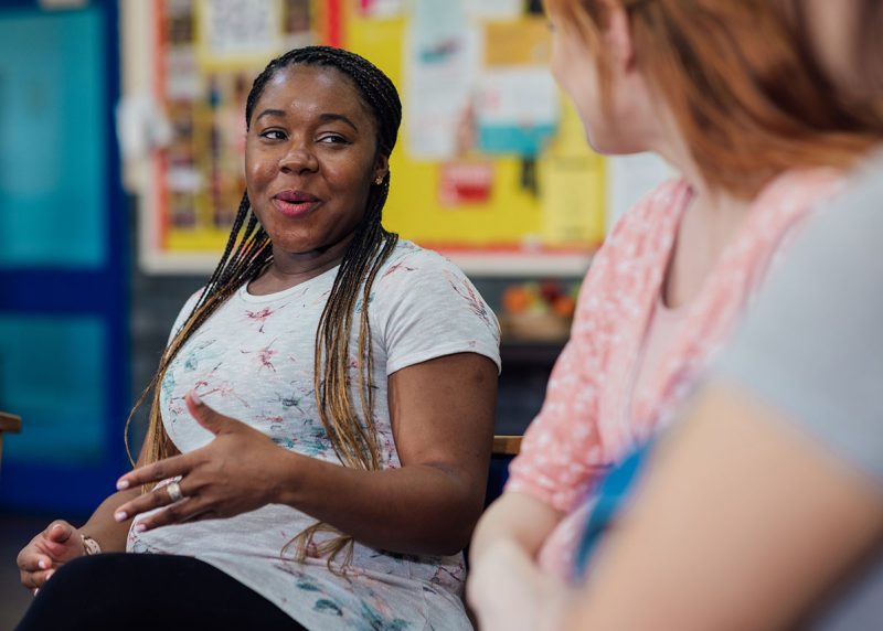 Woman smiling and talking.