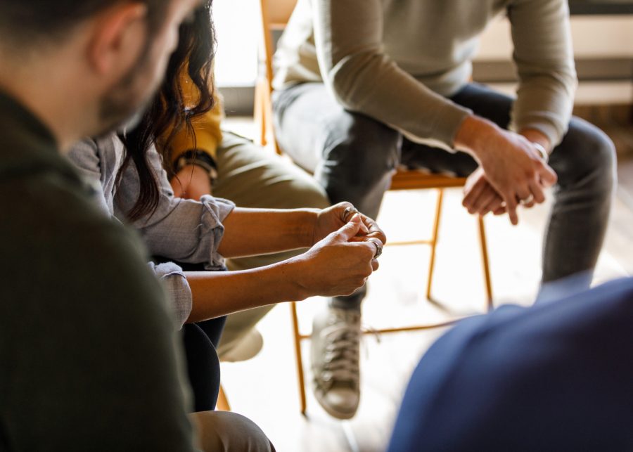 A diverse group of people sitting in a circle.